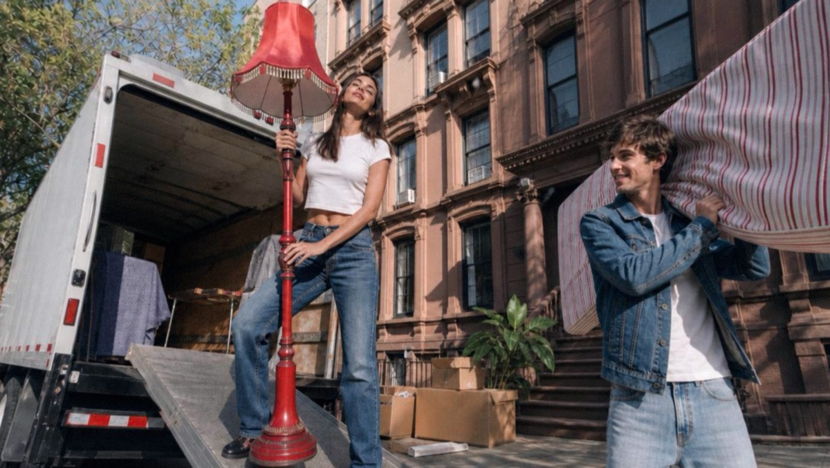 Moving truck on a brownstone street with a red lamp and a mattress
