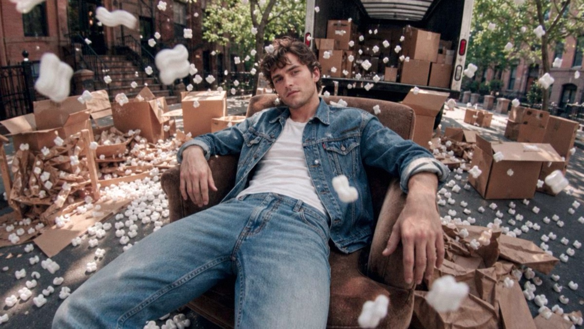 Man in an armchair in the street, packing peanuts flying